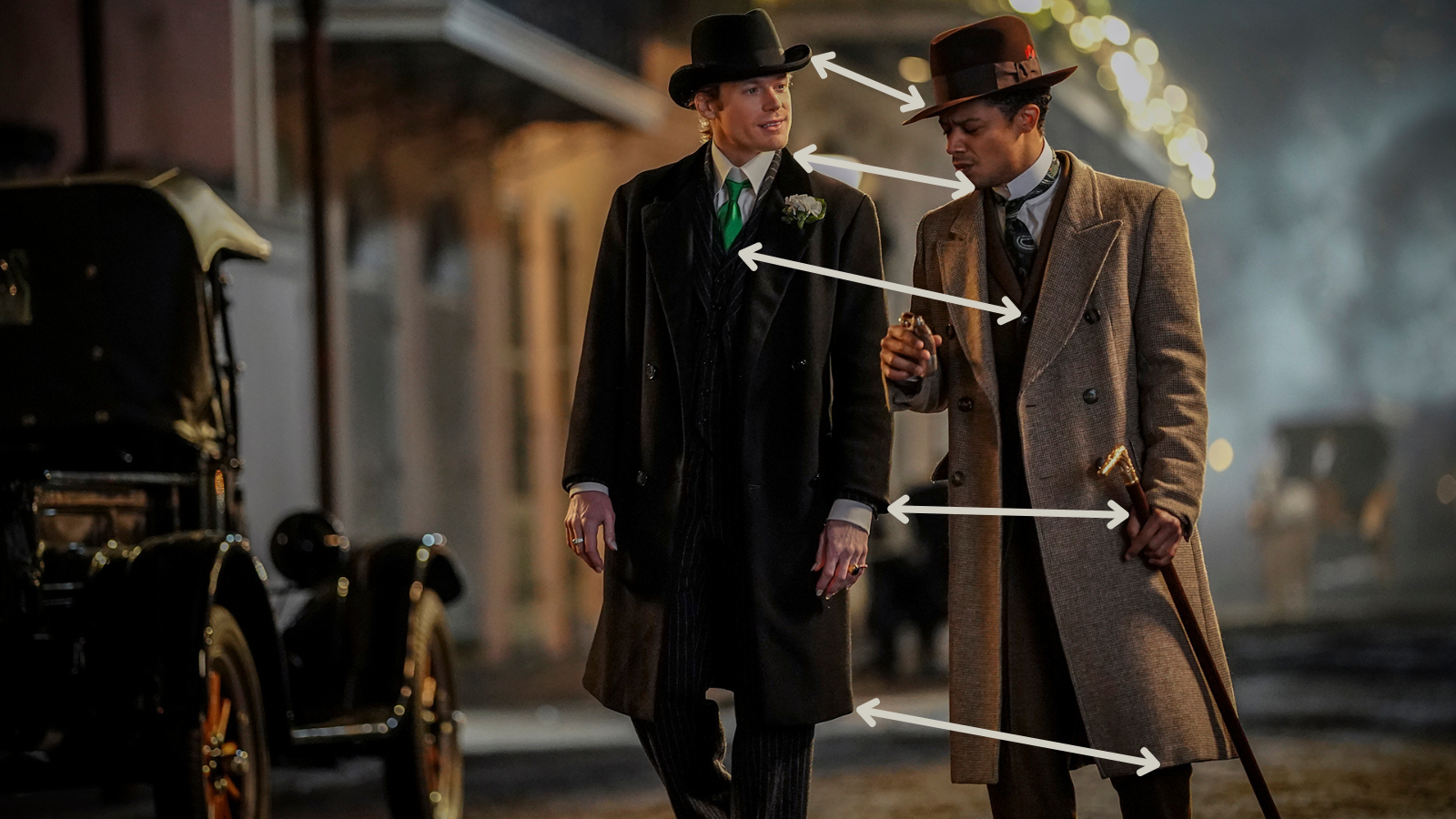 The same picture of Lestat and Louis in the French Quarter, this time with arrows pointing out differences in their outfits.