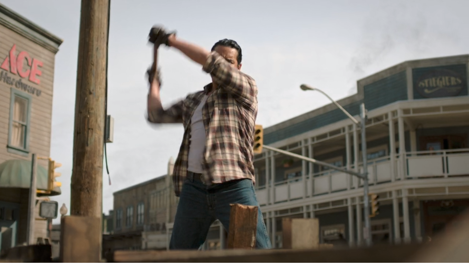 Tommy working on repairs in episode three. There is a well kept ACE Hardware logo on the building to his left.
