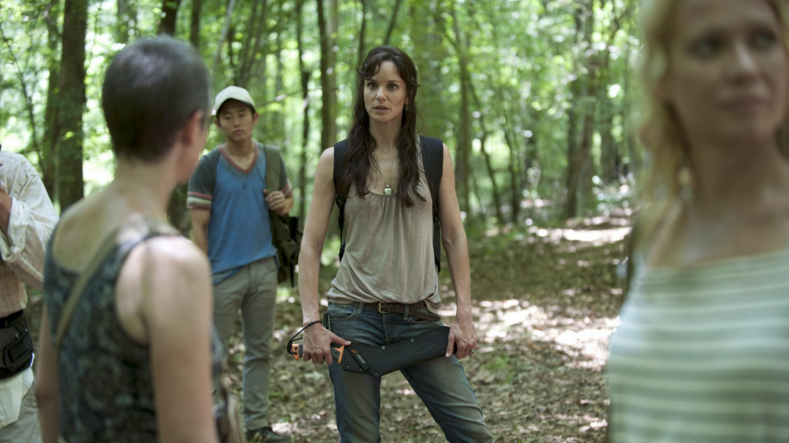 Characters in the woods in The Walking Dead season two. They all have clothing which is various levels of worn down.
